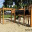 Eragon Spielanlage mit Tunnel und Rutsche auf einem Spielplatz mit Sandboden.