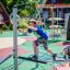 Kinder spielen auf der Kletterkombination Seestern im Freien.