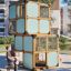 Breezekiste mit Rutsche moderner Spielturm aus Holz und Metall auf Spielplatz