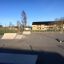 Skatepark mit Rampen und Hindernissen auf einem öffentlichen Platz, sonniger Tag.