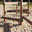 Kongo Wackelbrücke aus Holz auf einem Spielplatz mit Sandboden.