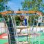 Kind auf einem Andromeda Klettergerüst mit Kletterwand auf einem Spielplatz.