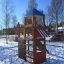 Kinder-Spielturm Logo Spielturm mit Feuerwehrstange im Schnee, mit Holzstruktur und blauem Dach.