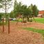 Dreifach Reck auf Spielplatz mit Rindenmulch Boden.